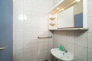 A bathroom with a white sink, a mirror, and a handrail. - Apartments Klis -studio Apartment With Terrace - 2 (Zupa dubrovacka)