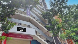 A multi-story building with balconies and a sign that reads 'NANDUS HOME'. - Super Collection O Manikonda (Hyderabad)