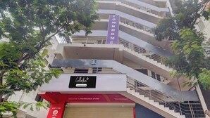 A multi-story building with a sign indicating 'Townhome' and a store named 'Manikonda Store' with operating hours from 8 am to 8 pm. - Super Collection O Manikonda (Hyderabad)
