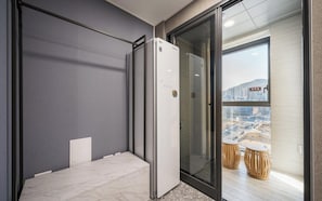 A modern bathroom with a glass shower enclosure, a white toilet, and a marble floor. - Gijang Ilgwang The Muse Hotel (Busan)