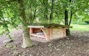 A wooden birdhouse structure nestled among trees in a park. - 4 bedroom gorgeous home in Lemvig (Lemvig)