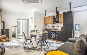A modern kitchen with a central island, wooden cabinets, and a built-in oven. - Beautiful home in Lepoglava with WiFi (Lepoglava)