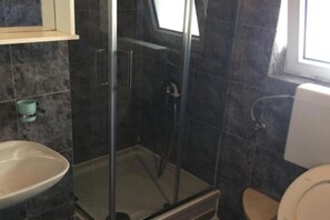A bathroom with a glass-enclosed shower, a sink, and a toilet. - Apartments Roza - Studio Apartment with Sea View (Herceg Novi)