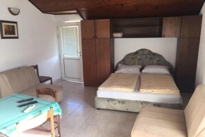 A compact room with a bed, a small table, and a chair. - Apartments Roza - Studio Apartment with Sea View (Herceg Novi)
