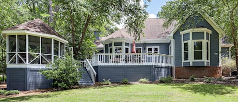 A two-story house with a covered porch and a separate garage.