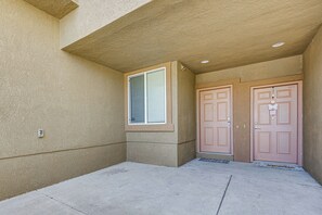 A building entrance with a concrete floor, a window, and two doors. - Pool Access & Balcony! Colorado Springs Getaway (Colorado Springs)