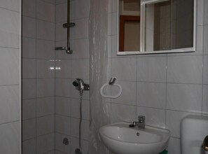 A bathroom with a shower, a sink, and a mirror. - Dugi Rat Seaside Apartments - 2 Bedroom 6 (Dugi Rat)