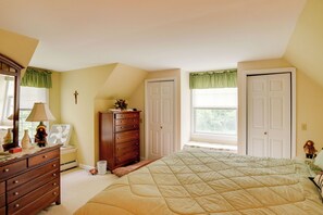A bedroom with a bed, dresser, and a window with curtains. - Deck & Wooded Views! Rural Windham Group Retreat (Windham)