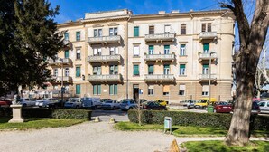 A multi-story building with balconies and a parking area in front. - Charming and Historic Old Town Apartments - Studio Apartment (Zadar)