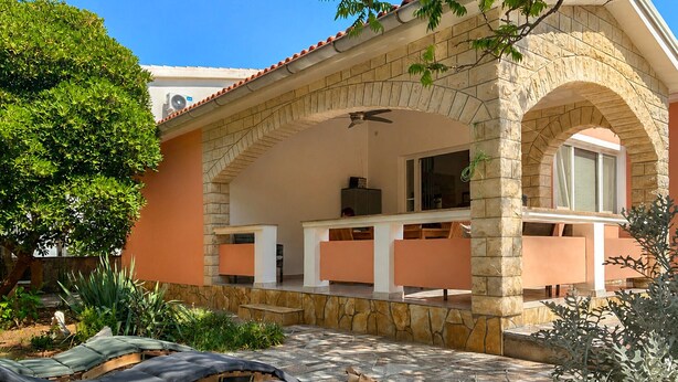 A house with a stone facade, a covered patio area, and a view of the surrounding garden. - 2 bedroom awesome apartment in Vir (Vir)