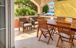 An outdoor patio with wicker furniture, a tiled floor, and a view of the street. - 2 bedroom awesome apartment in Vir (Vir)