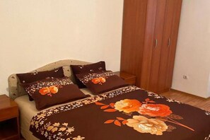 A bedroom with a bed, two pillows, a nightstand, and a wardrobe. - Villa Teodora Mare - Family Suite with Balcony (App 1) (Petrovac na Moru)