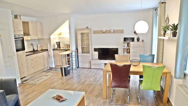 A modern living space with a kitchen, dining area, and seating. - Vacation Rental on Nordstrand—Close to the Beach and Comfortable—Comfortable (Dranske)