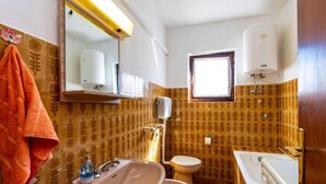 A bathroom with a sink, toilet, and a mirror. - Two Bedroom Apartment With Terrace (Preko)