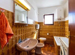 Ein Badezimmer mit Waschbecken, Toilette und Spiegel.