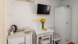 A kitchenette with a white countertop, a coffee maker, and a small cabinet. - Guest House Lumin - Twin Room With City View (Dubrovnik)