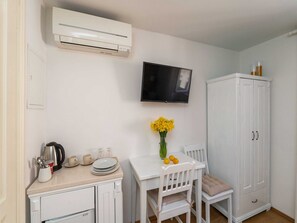 A kitchenette with a white countertop, a coffee maker, and a small cabinet. - Guest House Lumin - Twin Room With City View (Dubrovnik)