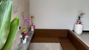 A modern interior with a marble countertop, potted plants, and a built-in bench. - 2 Bed Room Villa with Private Pool (Singaraja)