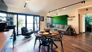 Un espacio habitable moderno con comedor, sofá y mesa de centro.
