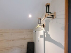 A room with wooden panel walls, a white radiator, and a black chair. - Frostana 1600, (Champoussin), by Interhome (Champoussin)