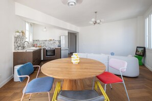 A modern kitchen with a marble backsplash, a built-in oven, and a stainless steel refrigerator. - Bright and Spacious 1BDR in Central Paris (Paris)