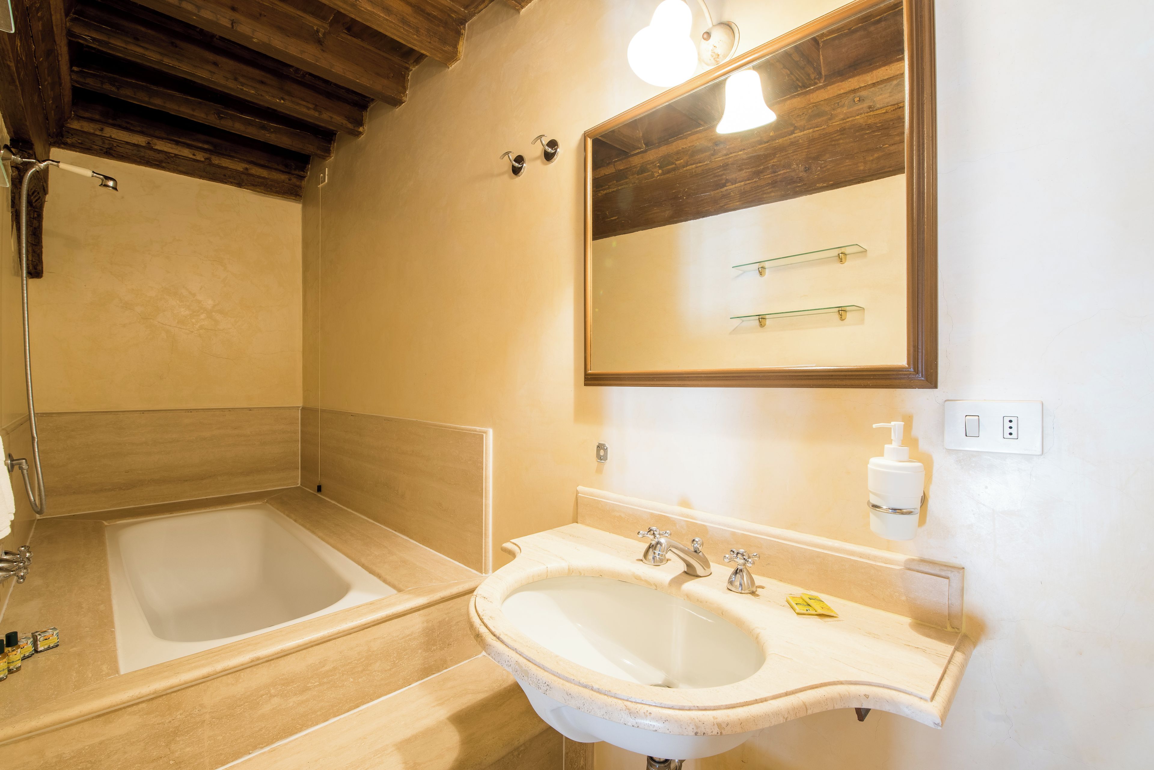 A bathroom with a bathtub, a sink, and a mirror.