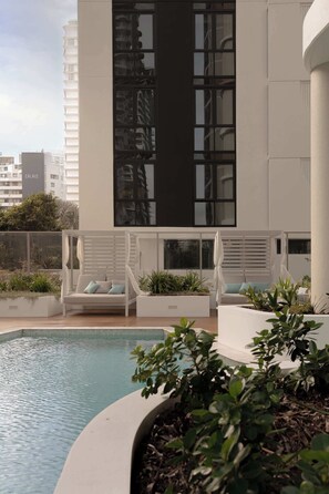 A rooftop pool area with lounge chairs and planters. - The Lagoon, Main Beach (Main Beach)