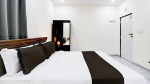 A hotel room with a bed, a wardrobe, a door, and a mirror. - Super Collection O Vanasthalipuram (Hyderabad)