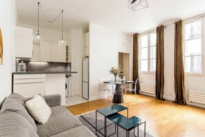 Een modern appartement met keuken, eethoek en woonkamer.