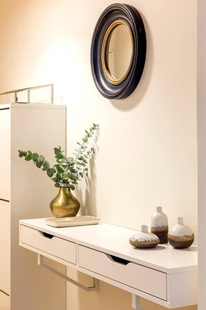 A bathroom with a white vanity, a gold vase with green leaves, and three decorative vases on the counter. - Elegant apartment near Place Vendôme - 1 bedroom - long stay - Madeleine I by Habitat Parisien (Paris)