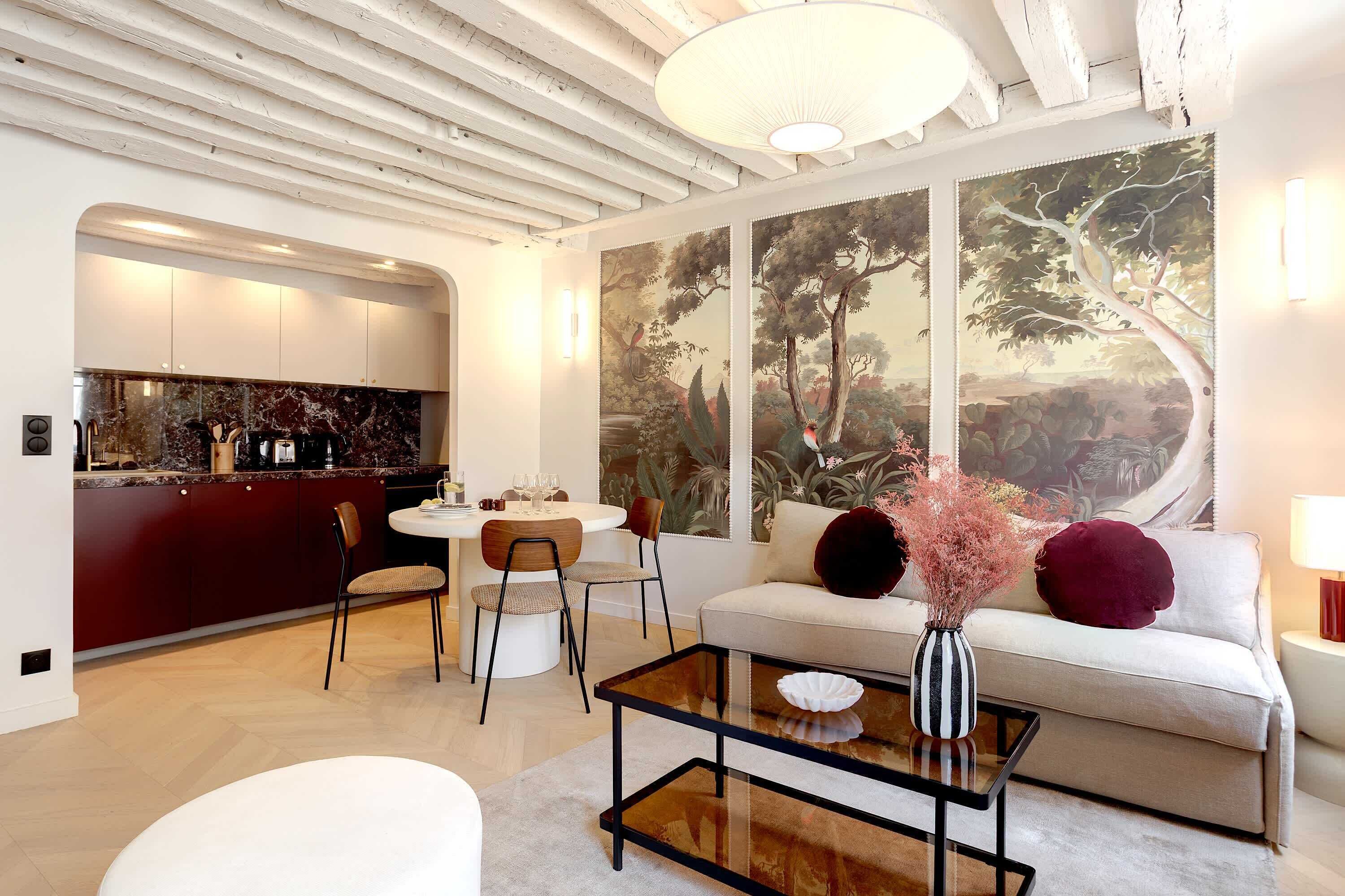 A modern living room with a sofa, coffee table, and dining area.
