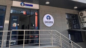 A building with a sign for 'Gagarin Capsule Hotel' and an entrance with a staircase. - Gagarin Capsule Hotel  (Almaty)