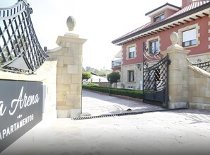 A gated entrance with a sign reading 'Arena Apartamentos.' - Apartment with Terrace, Pool, and Mountain Views (Miengo)