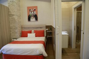 A hotel room with a bed, a nightstand, a wall-mounted painting, and a bathroom door. - Studio with Terrace and Pool (Miengo)