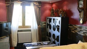 A living room with a sofa, a television, a radiator, and a decorative cabinet. - Casa La Arena with Pool (Miengo)