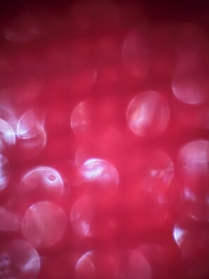 A blurred view of a red background with indistinct shapes. - Abcdefghil (Termoli)