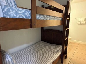 A bunk bed with a lower bunk and a mattress with a striped pattern. - Gulf Front Condo with Pool, Hot Tub & Beach Access (Panama City Beach)