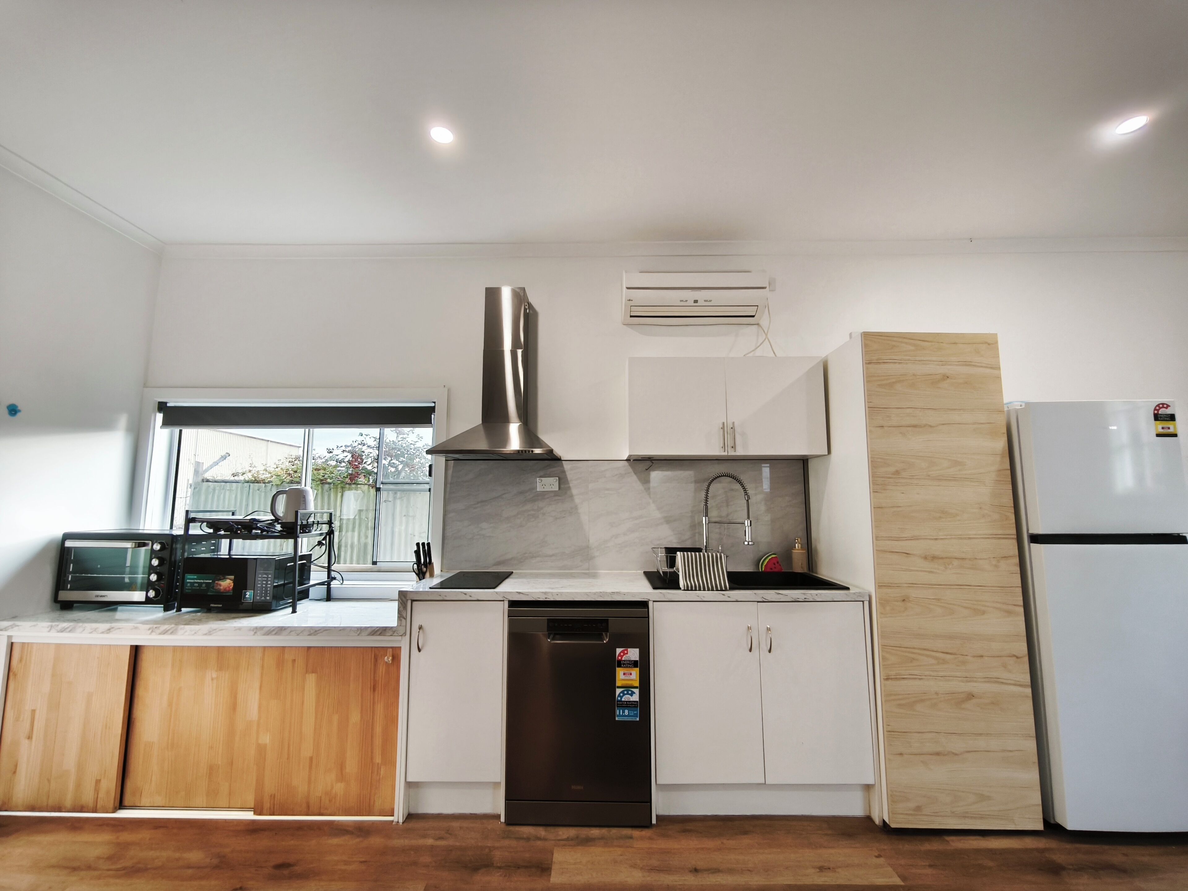 Una cocina moderna con horno empotrado, lavavajillas y refrigerador.