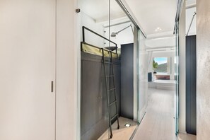A modern room with a bunk bed, a ladder, and a desk with a lamp. - [LaFinestraSulMare] Parking+A/C/Portovenere/5Terre (Portovenere)