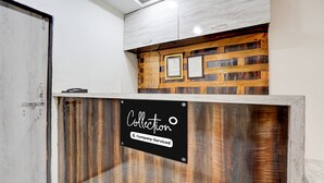 A reception desk with a wooden finish and a sign indicating it is company-serviced. - Super Collection O Daulatabad Fort (Chhatrapati Sambhajinagar)