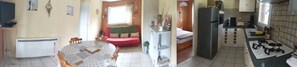 Een knus woongedeelte met een eethoek, een kitchenette en een klein zithoekje.