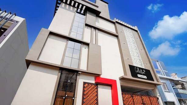 A modern building with a prominent vertical structure, large windows, and a sign indicating it is a company-serviced collection. - Super Collection O AIIMS Bhubaneshwar (Bhubaneshwar)