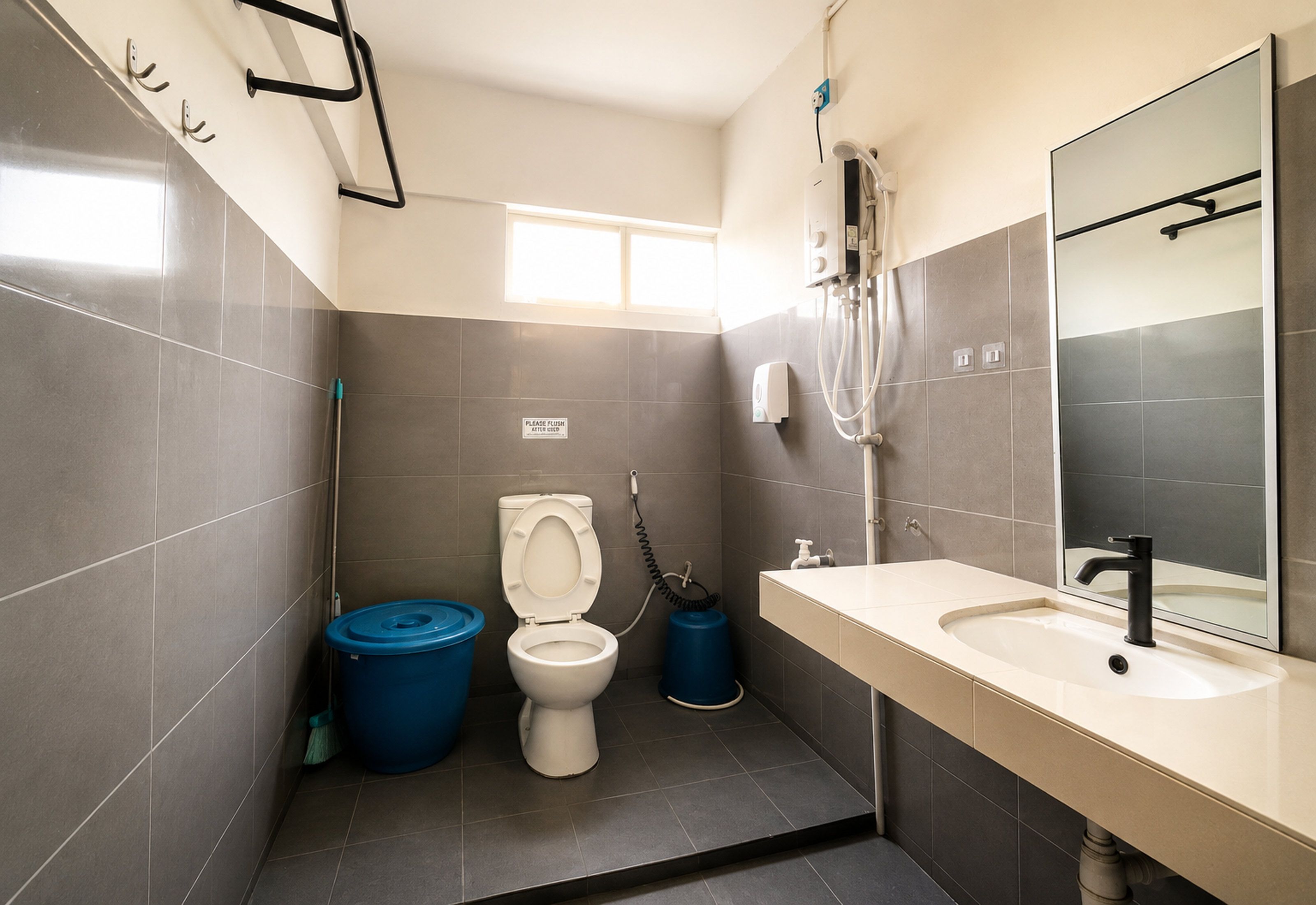 A modern bathroom with a toilet, bidet, and sink.