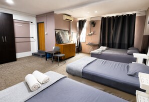 A hotel room with two beds, a desk, a chair, a wardrobe, and a mirror. - Hotel O HR Inn Resthouse Services (Kuala Krai)