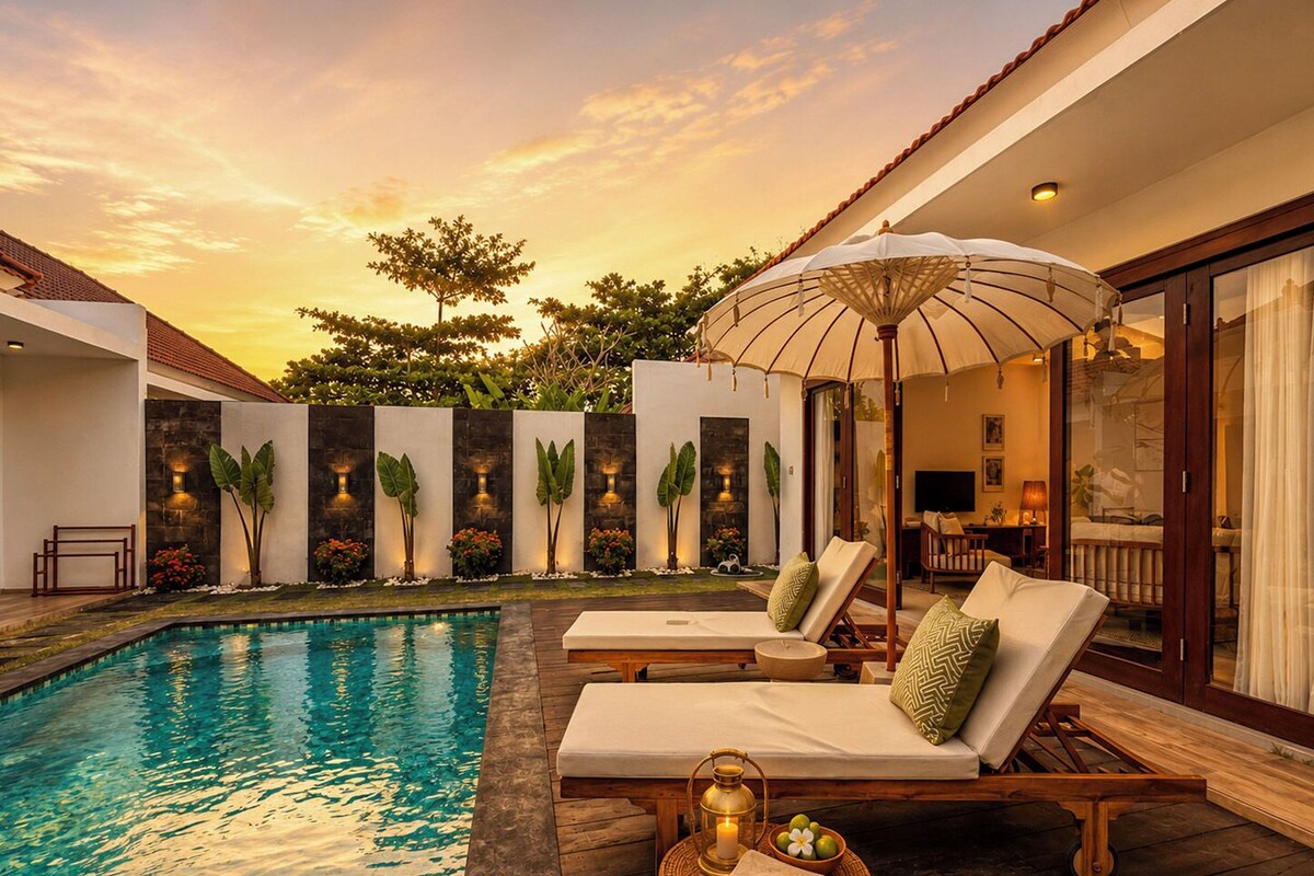 A poolside area with lounge chairs, a canopy, and a small table with a lantern.