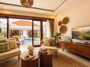 A spacious living room with a pool, comfortable seating, and a television. - 2 Bedroom Pavilion Pool Villa Canggu (Bali)