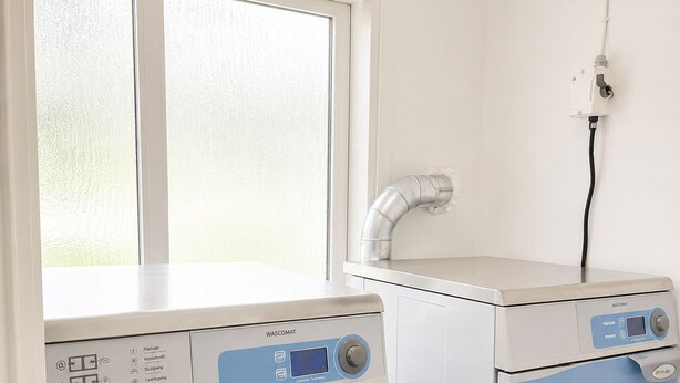 A compact laundry room with a front-loading washing machine and a stacked dryer. - Bokloster Longstay (Stockholms län)