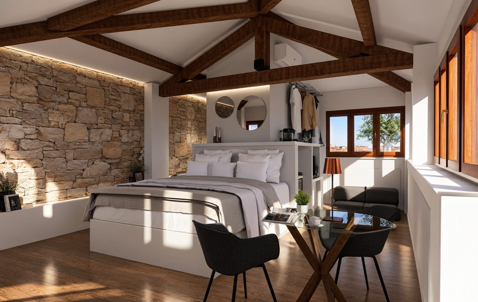 A bedroom with a stone wall, a bed, a desk, and a chair.