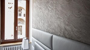 A room with a large window, a radiator, and a textured wall. - Residenza Duomo3 Apartments (Verona)