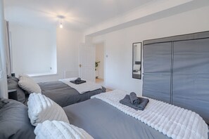 A hotel room with two beds, a large mirror, and a view of the hallway. - 3BR House w Parking Family-friendly Sleeps 8 (London)